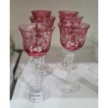 Set of six cranberry flashed cut glass wines, each with everted rim, leaf and ovolo cut, on