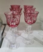 Set of six cranberry flashed cut glass wines, each with everted rim, leaf and ovolo cut, on