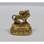 Small Georgian gold seal, rounded oblong, ribbed and floral, the mount in the form of a lion and