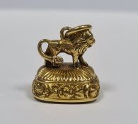 Small Georgian gold seal, rounded oblong, ribbed and floral, the mount in the form of a lion and