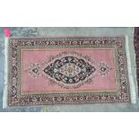 A modern Persian style rug , pink ground,  central medallion, floral decorated with borders in