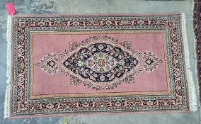 A modern Persian style rug , pink ground,  central medallion, floral decorated with borders in