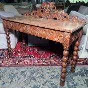 Victorian oak side table, the grape on vine carved and pierced back above the rectangular top with