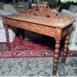 Victorian oak side table, the grape on vine carved and pierced back above the rectangular top with