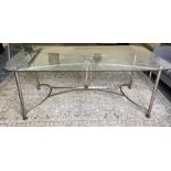 Modern dining table, the rectangular glass top with rounded corners, on metal stretchered base (