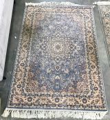 A Persian style wool rug,  light blue ground all over, floral decoration in pink, cream and dark