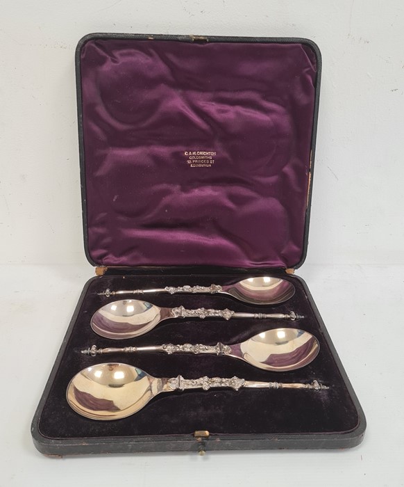 Cased set of four silver serving/ceremonial spoons, turned finial with handle decorated with lion