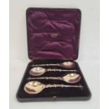 Cased set of four silver serving/ceremonial spoons, turned finial with handle decorated with lion