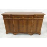 20th century yew breakfront sideboard with four drawers above four cupboard doors, bracket feet,