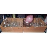 Two boxes of mixed glasses including champagne flutes, beer glasses and a large pink opaque vase