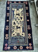 Eastern style rug with cream ground and blue borders, decorated stylised deer, birds and other