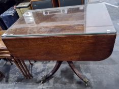 19th century mahogany Pembroke table on single pedestal to four reeded swept legs, brass caps and