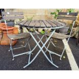 Iron-framed and wooden-slatted top circular garden table, diameter 75cm with two matching folding