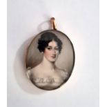 Regency portrait miniature on ivory, oval, head and shoulders of a lady in gold-coloured frame, with