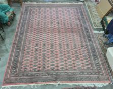 Persian rug, red ground, multi gold in cream and green rectangular lozenge, with multi-border;