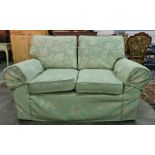 Two two-seater sofas and single armchair in pale green foliate pattern upholstery