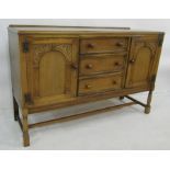 20th century oak sideboard with three drawers flanked by cupboard doors, block supports, 138cm x