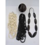 A carved ebony necklace, a black stained wood necklace, multi layered, a resin /wood multi layered