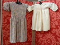 Child's silk dress with Liberty-style print, with frilled front, pockets and tie back and three silk