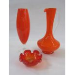 Orange glass jug with clear glass handle, an orange glass vase of elliptical shape with clear
