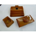 An Art Deco Carvacraft amber resin inkwell, blotter and desk tidy (3)