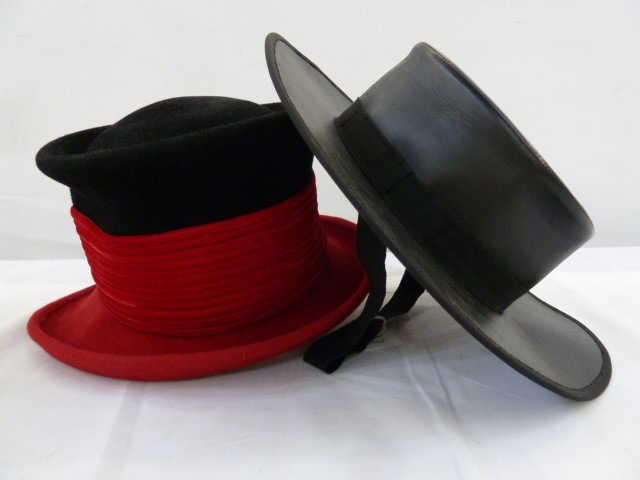Philip Treacy black and red wool chimney pot-style felt hat and a Spanish leather riding hat