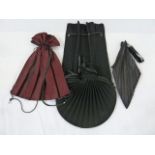 Issey Miyake pleat circular drawstring bag with leather trim, an Issey Miyake pleat bag in black