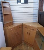 Pair of 20th century oak G-Plan corner cupboards, each with single drawer above two cupboard