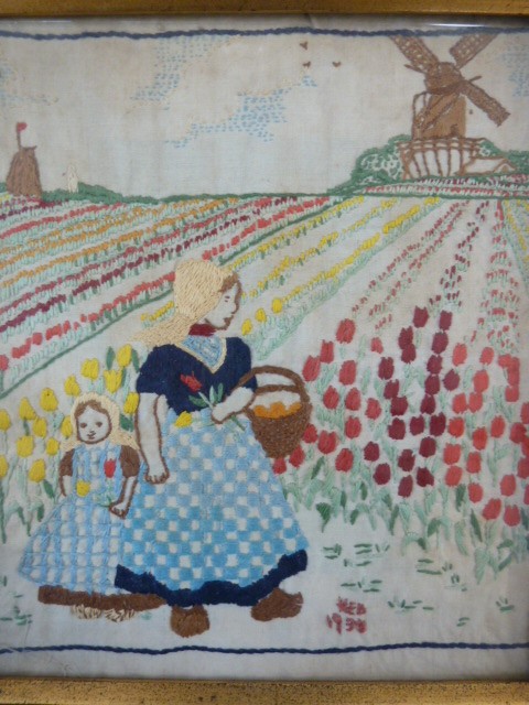 Early 20th century embroidery depicting mother and child among tulip field, with windmill in