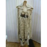 1970's heavy knitted cape with knitted frill detail and appliqued rosettes and feathers, hooded