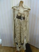 1970's heavy knitted cape with knitted frill detail and appliqued rosettes and feathers, hooded