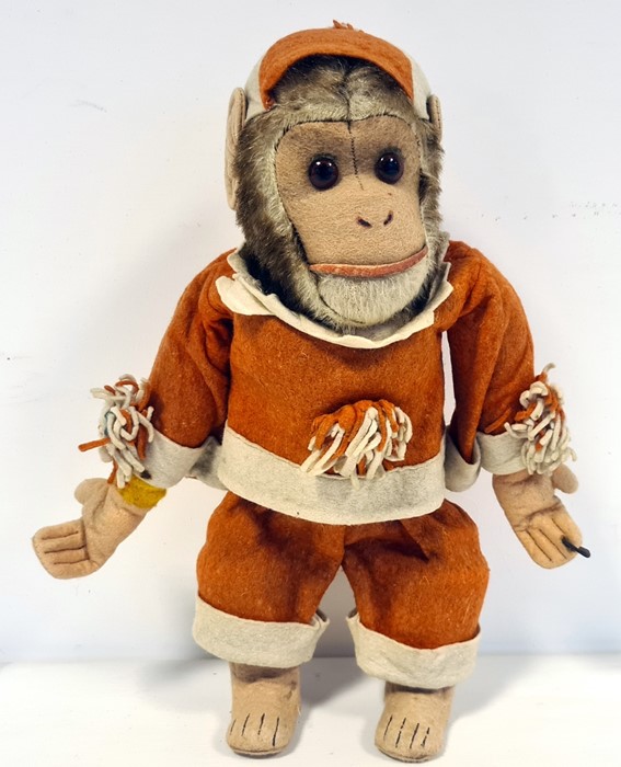 Monkey automaton with key wind up to reverse, in red and white jester's style outfit