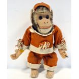 Monkey automaton with key wind up to reverse, in red and white jester's style outfit