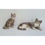 Large Winstanley reclining tabby cat, 41cm long approx and another seated, 25cm high (2)