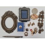 Silver cased propelling pencil, a brass picture frame of oval form with cold painted flowers, a