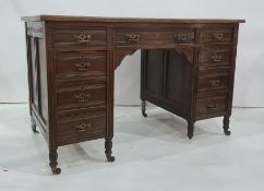 Late Victorian oak desk with leatherette inset top, moulded edge, nine assorted drawers with