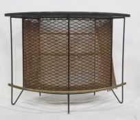 20th century bowfront bar with plain black top, with grill front, three shelves and brass tubular