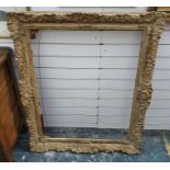 Large plaster and giltwood picture frame of rectangular form with shell and scroll border, 113