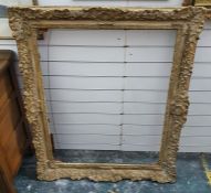 Large plaster and giltwood picture frame of rectangular form with shell and scroll border, 113