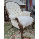Victorian mahogany framed chair in a cream brown button back upholstery, carved exposed frame to