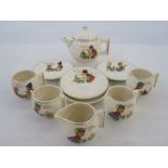 Child's part tea service comprising teapot, four cups and saucers and milk jug 'Dolly's Bedtime', '