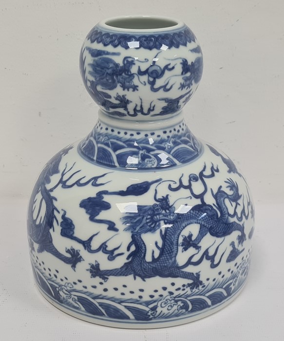 Chinese porcelain double-gourd vase with broad flat base and underglaze blue decoration of dragons