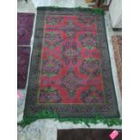 Eastern, possibly Turkish, red ground rug with repeating motifs, in red, green, blue design and
