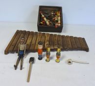 Wooden xylophone, wooden jointed figure of a man, wooden skittles, marbles and miniature child's