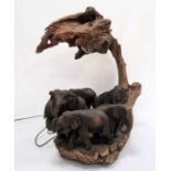 Statement table lamp constructed from driftwood and with a family of carved wooden elephants,
