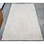 A modern cream ground rug with stylised rectangular design, 238 x 156cm