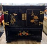 Oriental style black lacquer cabinet, two doors enclosing open recessed three drawers with long