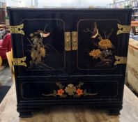 Oriental style black lacquer cabinet, two doors enclosing open recessed three drawers with long