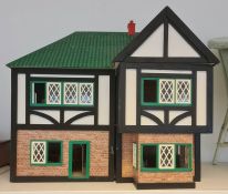 20th century doll's house in the Tudor style with various 20th century doll's house furniture and