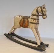 Painted wooden rocking horse, the white horse with  saddle and bridle on green highlighted